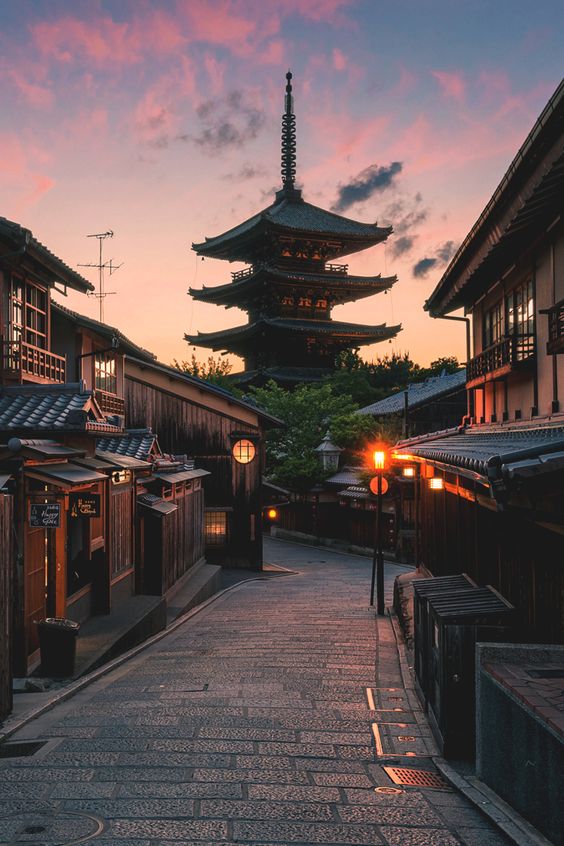 The colors of sunset burst behind the pagoda of Yasaka Shrine in Kyoto, Japan
